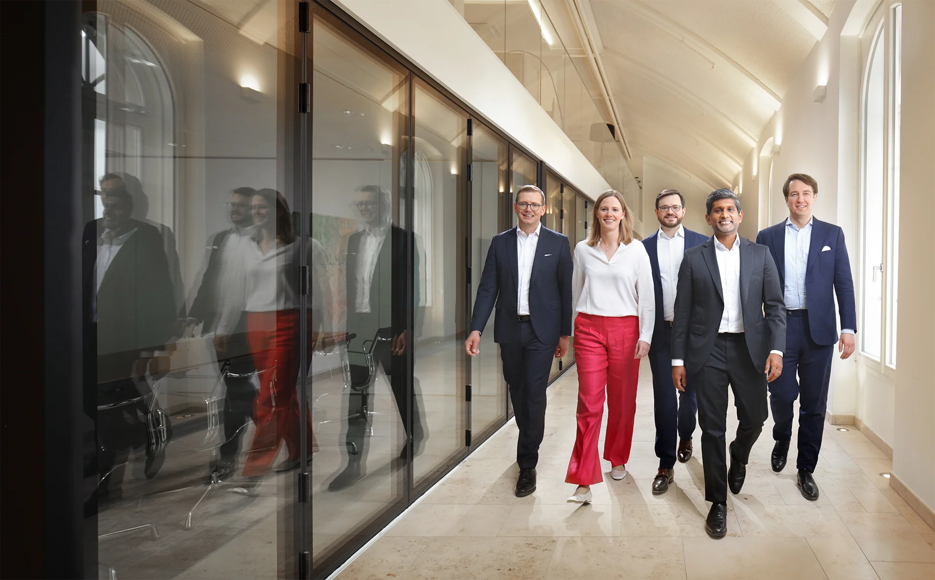 DLA Piper employees are walking down a hallway.