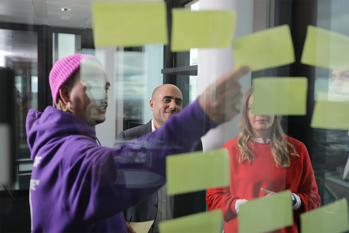 Teferie Tafesse stands with lawyers in front of a glass wall and discusses the next steps